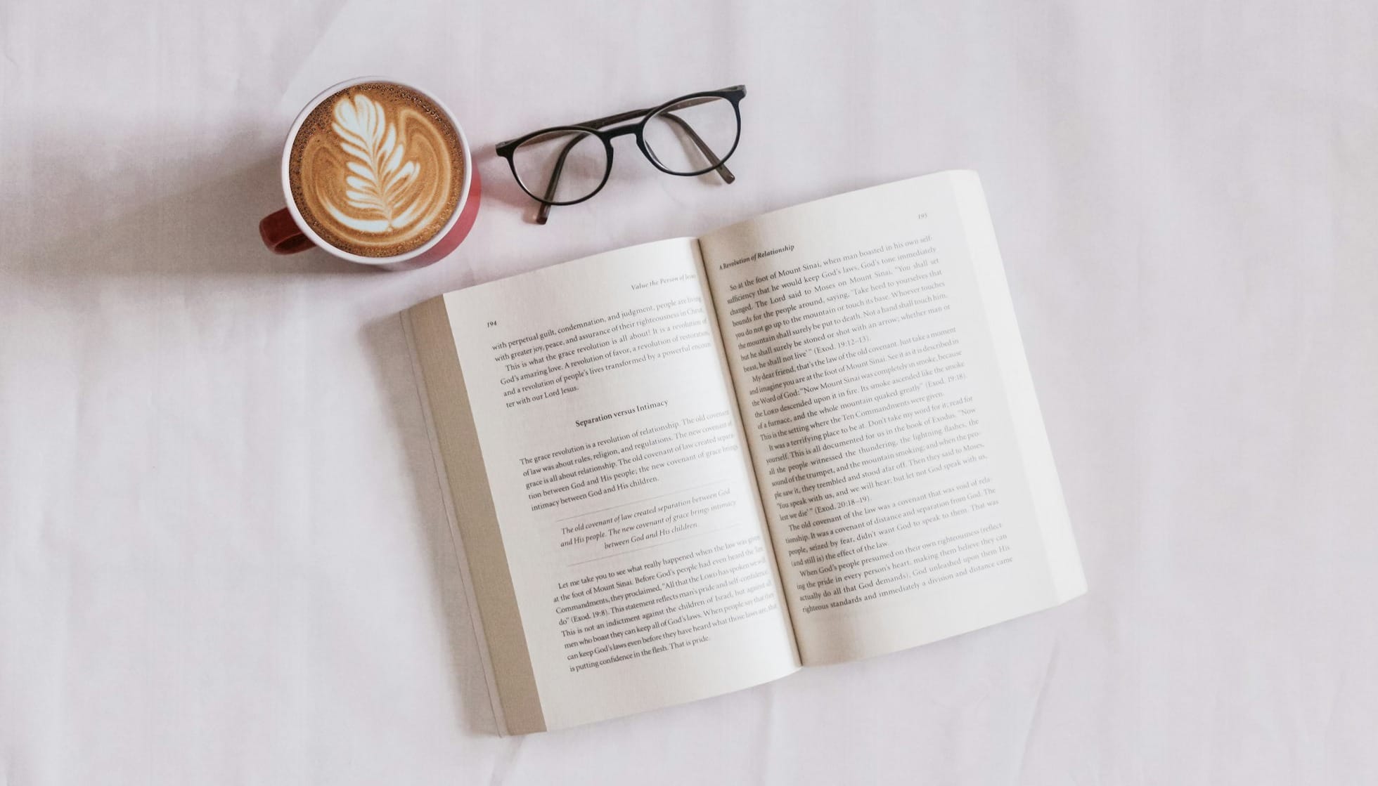 book near eyeglasses and cappuccino